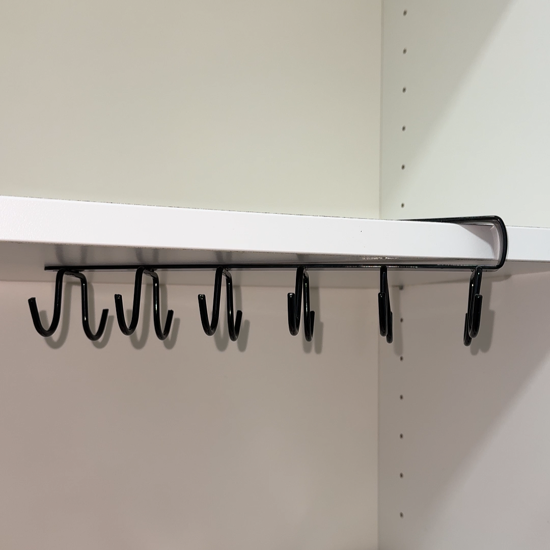 A versatile 6-hook under-shelf organizer designed for artists to keep brushes, aprons, and tools neatly stored and within easy reach, perfect for creating an organized art studio.