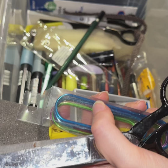 Video showcasing a 6-hook under-shelf organizer, ideal for artists to hang brushes, aprons, or tools, maximizing storage space in art studios while keeping essentials organized and accessible.